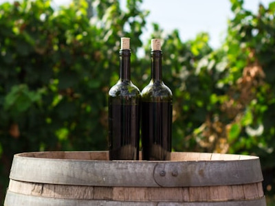  TWo wine bottles on a barrel 