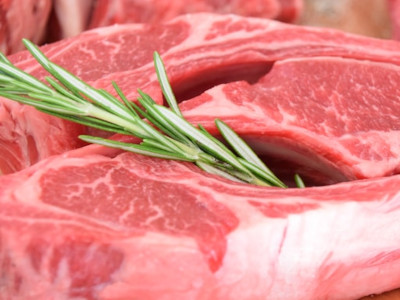  Raw steak with sprig of herb 